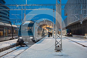 Trains waiting at Bergen train station in early morning ready to depart to the capital. People gathering in front of the train to