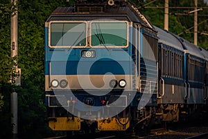 Trains and whistle stop Olesko in central Bohemia in sunset orange evening