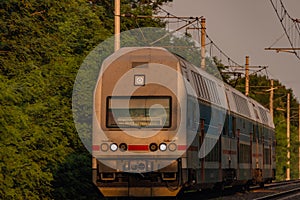 Trains and whistle stop Olesko in central Bohemia in sunset orange evening