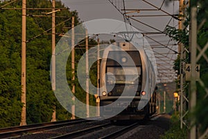 Trains and whistle stop Olesko in central Bohemia in sunset orange evening