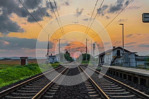 Trains and whistle stop Olesko in central Bohemia in sunset orange evening