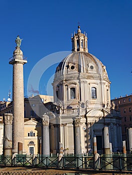 Trajan`s Column and Chiesa SS Nome di Maria Basilica in Rome, Italy