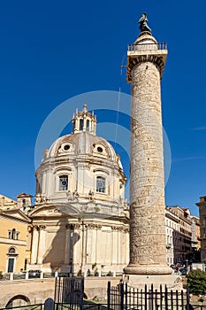 Trajan\'s Column and Church of the Most Holy Name of Mary at Trajan Forum in Rome, Italy