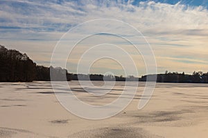 Trakai lake covered with ice in pleasant sunny cold winter day.