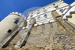 Trakoscan castle surrounded by the lake and forested hills