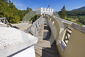 Trakoscan castle surrounded by the lake and forested hills