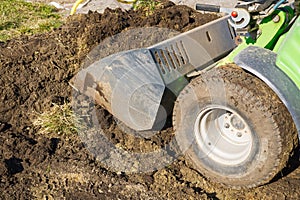 Traktor on the field. Mini traktor landscaping at home backyard