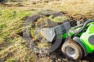 Traktor on the field. Mini traktor landscaping at home backyard