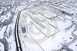 tram depot in winter. trams, tramway tracks and industrial buildings covered with snow. aerial photo