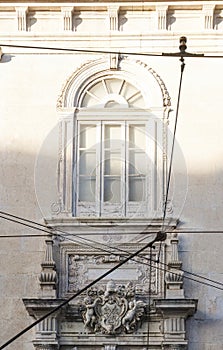 Tram in front of the Catholic Church in Lisbon with stucco and bas-reliefs with angels on the facade