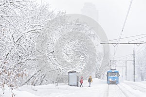 Tram goes during snowstorm in winter, Moscow, Russia