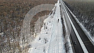 tram moves along the rails along the track in the winter season. 4k drone footage