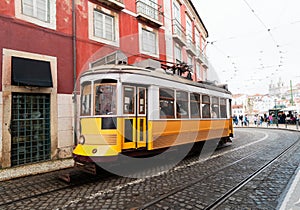 Tram on narrow street of Alfama, Lisbon