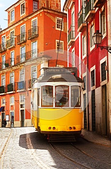 Tram on narrow street of Alfama, Lisbon