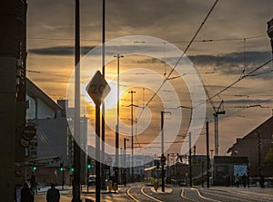 Tram and tramlines in Manchester, UK, with setting sun a