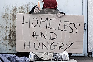 Tramp sitting on the street