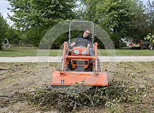 Tramping A Tree Limb Pile Down With A Front End Loader