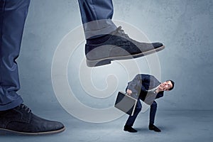 Trampled small businessman in suit