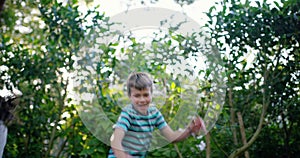 Trampoline, happy or kids jump in nature for fun games on holiday vacation to relax together. Wellness, bounce or