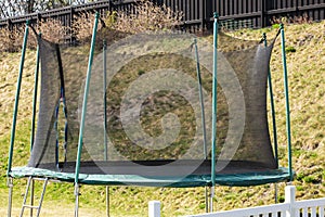 Trampoline with saftey net mounted on backyards. Outdoor activity concept
