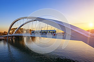 Tramway on the bridge at sunset
