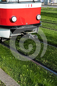 Tramway Drives On Iron Rails Through Green Grass