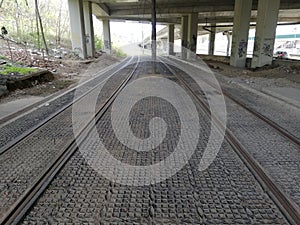 Tramway paralel tracks perspective under a bridge