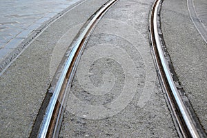 Tramway rails on grey asphalt,stone ground.