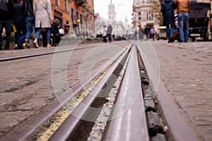 The tramway rails in the middle of the old cobblestone in the city