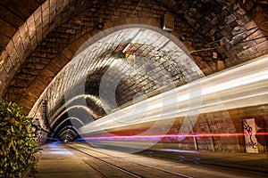 Tramway Tunnel at Night with Tram Light Trails