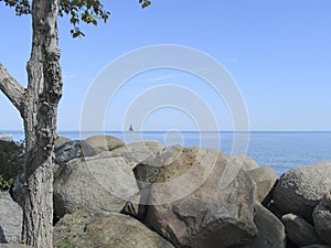 Scenery with sail boat on a late summer day