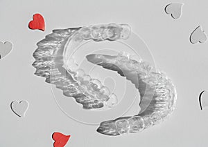 Tranparent Braces. Invisible aligners with paper hearts