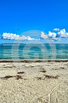 Tranqil and serene beach scene - sand, sky, sea, clouds