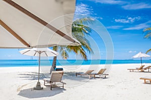 Tranquil beach lounge chairs and umbrella. Summer holiday and vacation concept background.