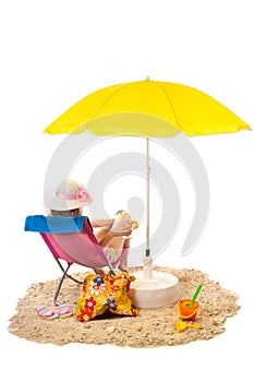 Tranquil beach with woman in chair