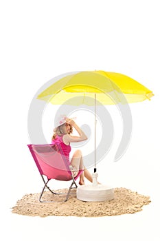 Tranquil beach with woman in chair