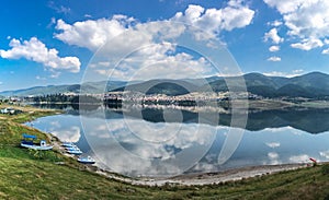 Tranquil lake reflecting the clouds and blue sky