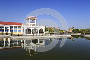 Tranquil lake with reflection of trees and house