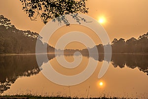 A tranquil lake through smoggy skies photo