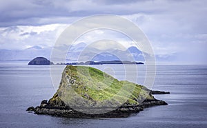 Tranquil landscape of Isle of Skye, Scotland,UK.Small islands on sea and mountains in background