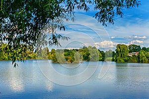 Tranquil landscape at a lake, with the vibrant sky and clean blue water