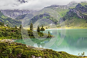 Tranquil landscape on the mountain lake Truebsee with turquois water