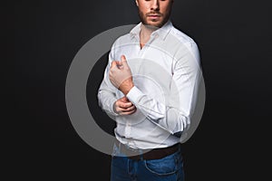 Tranquil male buttoning on cuff photo