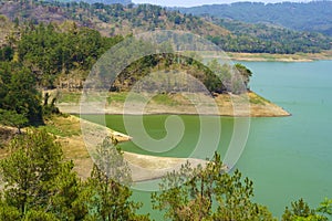 A tranquil man made lake nestled among towering peaks.