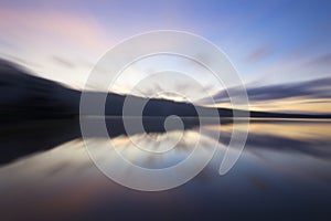 Tranquil morning view of colorful sunrise with blue sky over the lake with its water reflection background. New day, new beginning