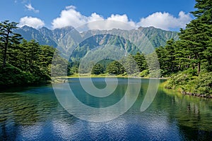 Tranquil Mountain Lake Surrounded by Evergreen Forests in a Scenic Wilderness Landscape photo