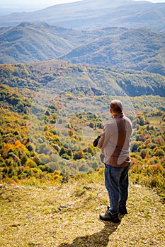 Tranquil Mountain Scenery: Man Enjoying the View from Sacred Peak Overlook
