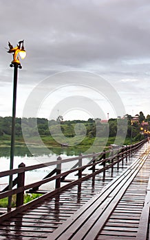 A tranquil old wooden bridge on rainy evening