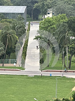 Tranquil Pathway Through Lush Urban Park with Cyclists