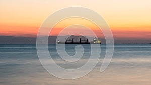 Tranquil Peaceful Scenery of Sea and big ship after Sunset, wit